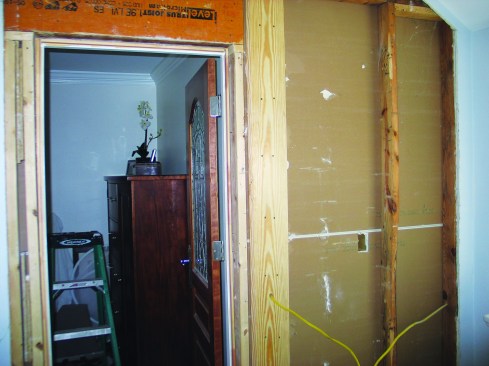 I then screwed the 5/4 by 6-inch backer board to the end stud of the perpendicular wall.