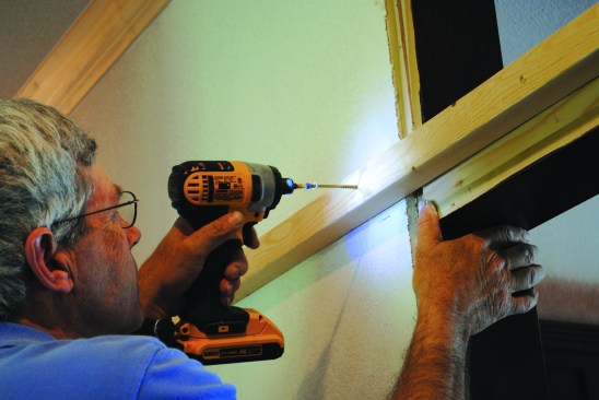 He then ripped a 2x6 in half and, using his line as a reference, centered the first piece on the opening and screwed it to the wall framing.