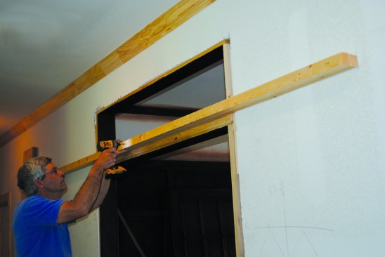 Screwing the second ripped piece to the first with the bottom edges flush to each other created a 3-inchwide header to attach the track to.