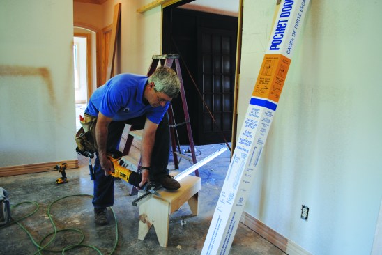 Using a reciprocating saw, the author cut the track from a standard lumberyard knock-down pocket-door frame into 62 3/4-inch lengths for each side, which would leave a space for inserting rollers in the middle.