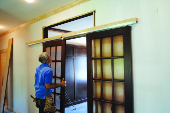 The rollers for the next panel slipped through the gap between the track pieces, allowing that panel to slide into the track on the other side.