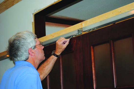 A tiny wrench that came with the pocket-door kit was used to adjust the height of the second panel until the two panels lined up perfectly. Adjusting the doors on the exposed track was much easier than adjusting a regular pocket door.