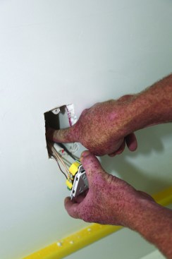 The author pushes the conductors into a back corner of the box.
