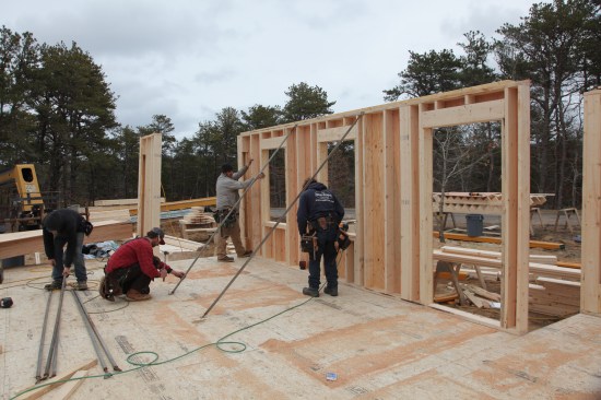 Up She Goes The crew raises the completed wall and then braces it plumb while adjacent walls are built.