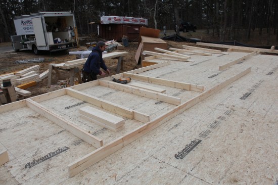 Kings and Jacks First The crew member distributes king-jack assemblies for each opening along with the appropriate width header. The kings and jacks are the first framing members to be nailed to the bottom plate.
