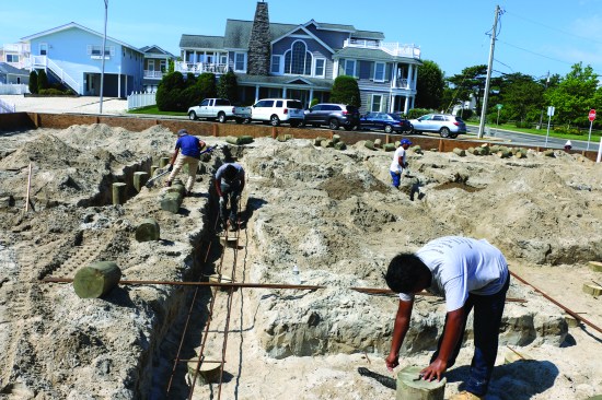 Next, three lengths of rebar sit atop the short pieces. Where two or more lengths are needed for a straight run, the pieces overlap and are tied together.