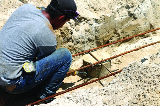 Finally, the crew bolts S-hooks to each piling to anchor the rebar.