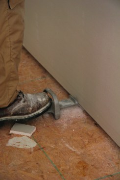 A drywall foot lift snugs the bottom sheet against the top sheet before fastening.