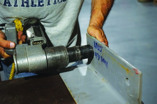After threading on the nut, a special wrench tightens it while gripping the splined end.