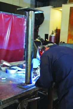 When satisfied that the base plate is tacked square to the column, the fabricator completes the weld along the entire joint.