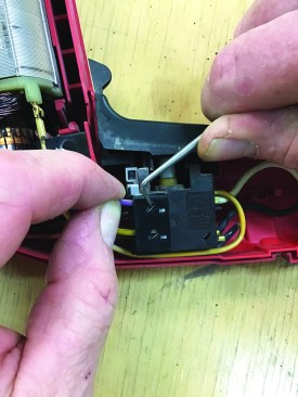 Before removing the wires, the author takes pictures of the switch and wires so he can make sure that he puts them back together properly. To remove the wires from the switch, he depresses springloaded metal keepers with a pick.