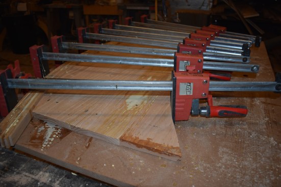 The author uses the pieces cut off of the blank as blocks to keep the clamps pulling at a straight angle.
