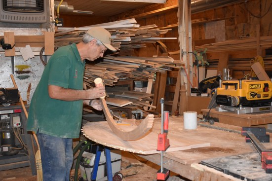 The author applies carpenters glue to the dominoes and to the inner surface of the trim.