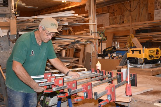 The author clamps the nosing to the stair blank, again using blocks to keep the clamps pulling at a straight angle.