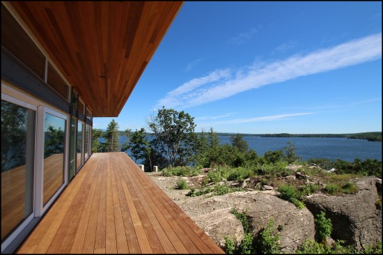 Figure 7. The south elevation was 80% glass. Large high-performance European-style lift-and-slide glass doors set in a steel moment frame (left exposed as an architectural feature) opened onto the ipe deck.
