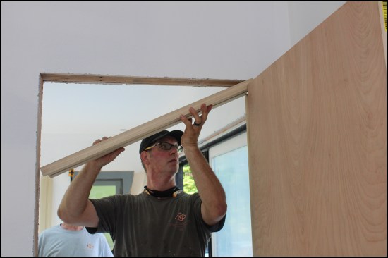 Next, Brady installs the header piece.