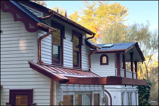 The copper roof, built-in gutter, and mahogany trellis installed.