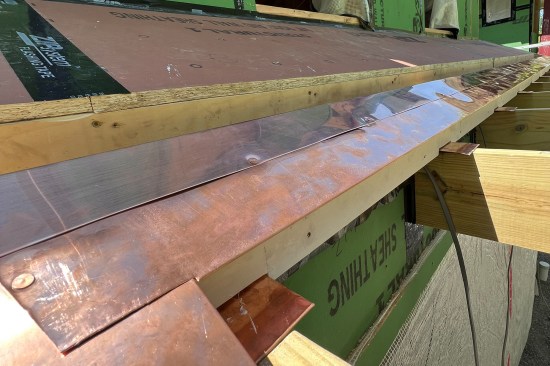 The gutter’s downslope edge is flashed with copper.
