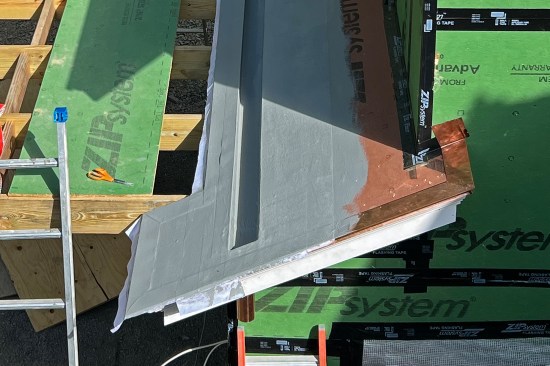 Then, the reinforced base coat was applied to the upslope side, run roughly 18 inches up the roof. (The small roof areas on either side of the trellis framing were also covered with Acrylabs).