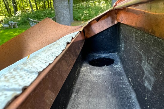 The dark-colored Acrylabs finish coat helps hide the built-in gutter from below and from the windows above.