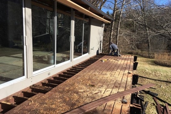 An New Dimension Construction crew member removes the existing ‘deck house’ decking.