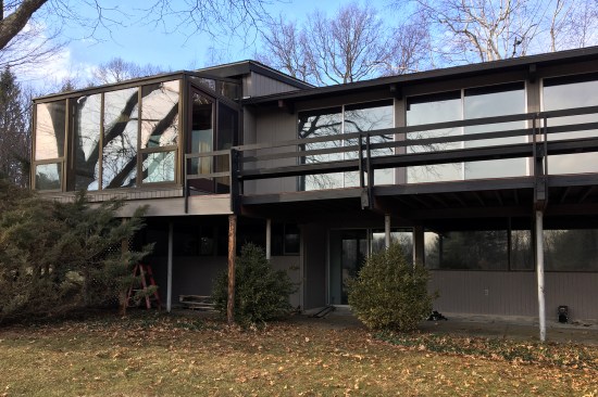 An ill-suited sunroom, not in keeping with the home’s style, that had been built on the left side of the deck.