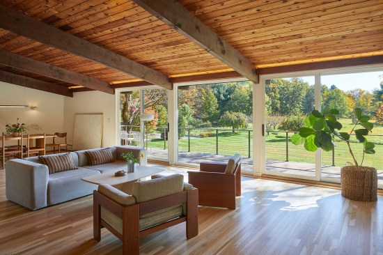 The finished living-dining area with the replacement deck shown beyond.