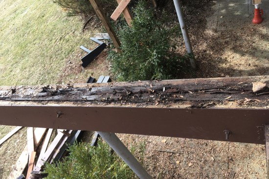 The previous builder had sandwiched the original 4x12s between two PT 2x12s (through-bolting them together) and ran a PT 2x4 on the bottom, encasing the fir in a pressure-treated “U.”