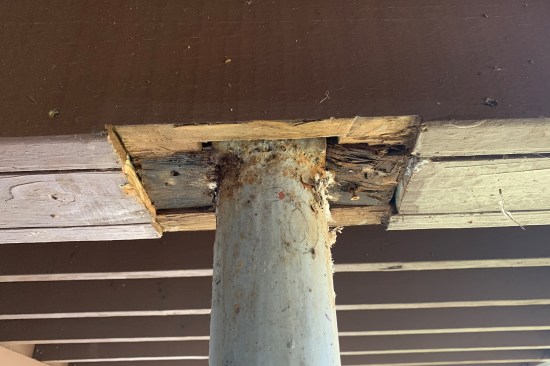 The steel saddle connections (welded to the steel columns) supporting the “cantilevered” ends of the beams had sunk into the rotted Douglas fir.