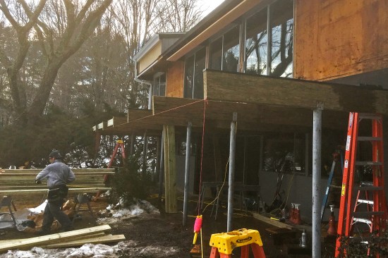 The cantilevered main-level floor and replacement deck are supported by seven 4x12 parallams. The existing steel columns were reused to support the ends of the new beams.