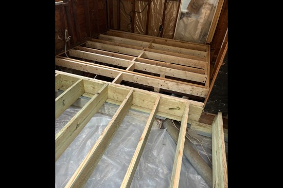 Floors out of level by 1 inch or more typically need to be reframed. Here, a new kitchen floor is being framed in an older home; the original floor was 3 inches out of level.