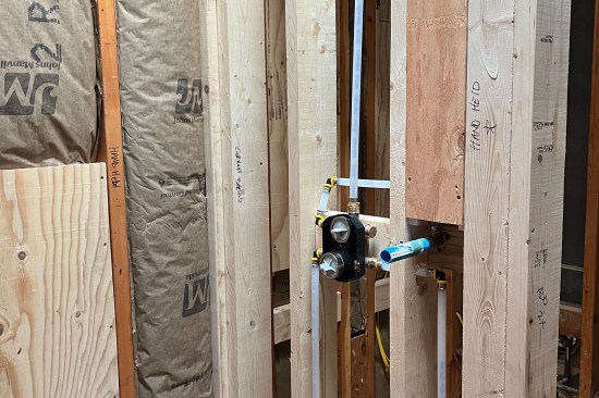 On a wet wall, critical items are marked on blocking and studs.