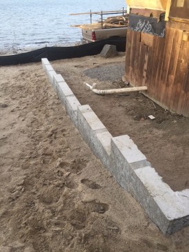 This portion of the foundation reconstruction is ready to serve as a retaining wall as well as a support for the building. But plans to re-grade the site were put on hold because of a city environmental review.