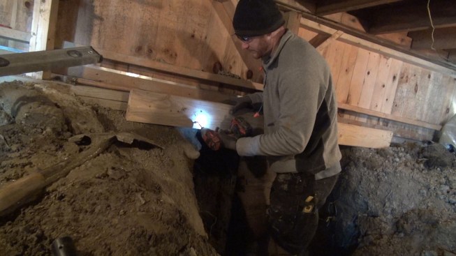 Chris shoots a screw into the temporary brace he will use to hold the Sonotube in place as he fills it.