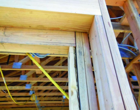 The lumber used to pack out this recessed window opening will be covered by the weather barrier and flashing tapes, so the trades that follow will have no way of knowing there’s a major void in the backing due to wane along one edge. A lath or trim nail puncturing the flashing over this void would more than likely leak.
