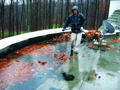 The small, 5-inch-by-5-inch scuppers in the parapet wall were inadequate to the task of draining this poorly sloped roof.