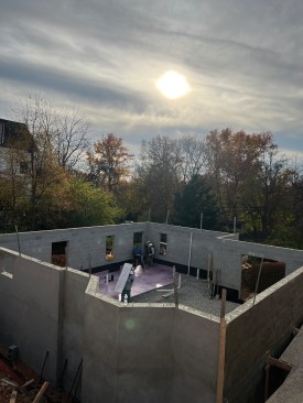 The block walk-out foundation was the first part of the new structure to be built on the sloped site.