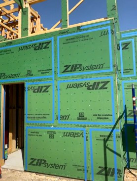 To seal the seams between sheathing panels, the author’s crew starts by outlining them with 2-inch-wide painter’s tape. 