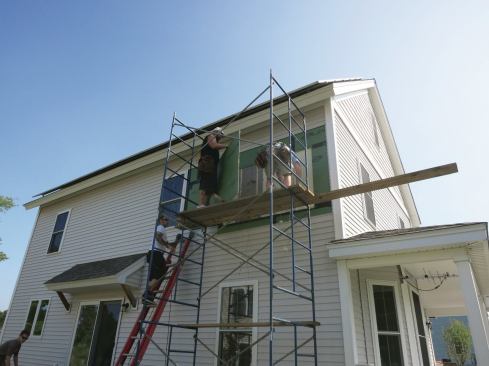 After a house in Devens, Mass., had its moisture and temperature monitored for three seasons, workers pulled sections of Zip sheathing panels from the test wall section.