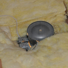 Recessed lights are a common source of air leakage, as shown by the light shining around this conventional can light viewed from the attic.