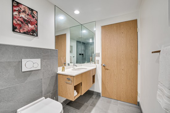 The narrow depth of the vanity in the second downstairs bath is just 20 inches, which made it possible to replace the 30-inch door with a wider, 34-inch model, in case wheelchair access is needed in the future.