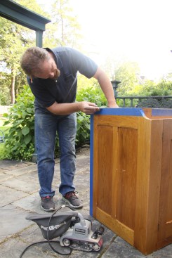 On finished panels like this bottom rail, he cuts the tape and the scribe line to prevent tear-out.