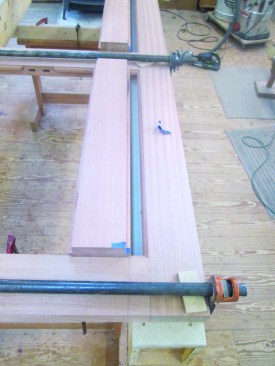 Once the frame is dry-fit and clamped, the author knows the exact length for the center stiles, so these can be cut.