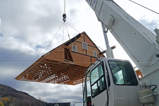 The big roof would be set first. Two steel I-beams carried its nearly 3-ton weight. Rigging this roof took three hours, setting it only 30 minutes.