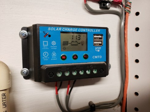 The solar panel is connected to a Solar Charge Controller. On sunny days the panel inputs about 14-volts of direct current to charge to the battery and has available USB ports for charging devices. This entire solar setup is available online for about $120.