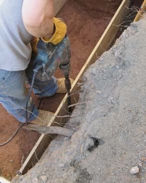 They are held in place with 30-inch form pins driven in with a rotary hammer.