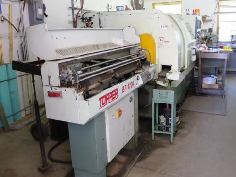 Bar stock is placed in the hoppers of these and other CNC machines, which cut the material to length and then machine them to the desired shape.