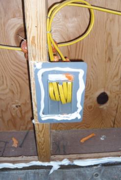 The drywallers applied painter's caulk to the plates, backers, and rough openings as they hung the wallboard, using two cases of caulk for the 750-square-foot structure.