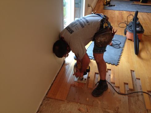 When a short length that needs to be removed won't budge using a hammer and chisel, Manny sets the blade of the circular saw at a slight angle and plunge into the board parallel with the grain. When the saw table makes full contact with the board, complete the rip through the end of the board.