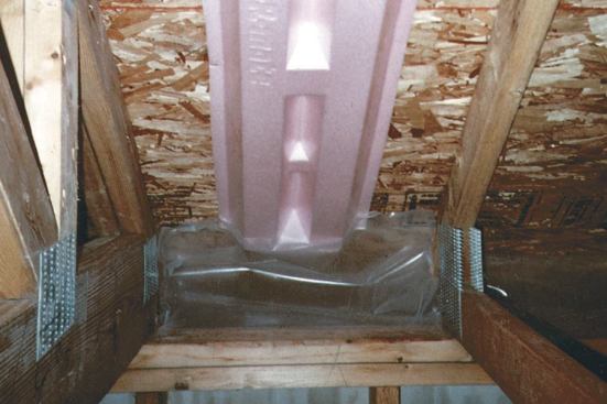 To keep the air from the soffit vents from disturbing the attic insulation, flaps of poly are stapled between the heels of the attic trusses. The vent channel only needs to extend above the expected depth of attic insulation.